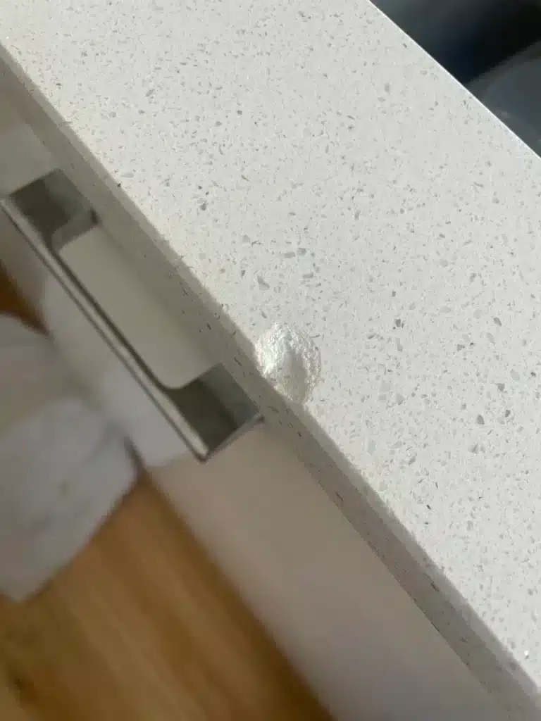 Chipped countertop edge repaired — before
