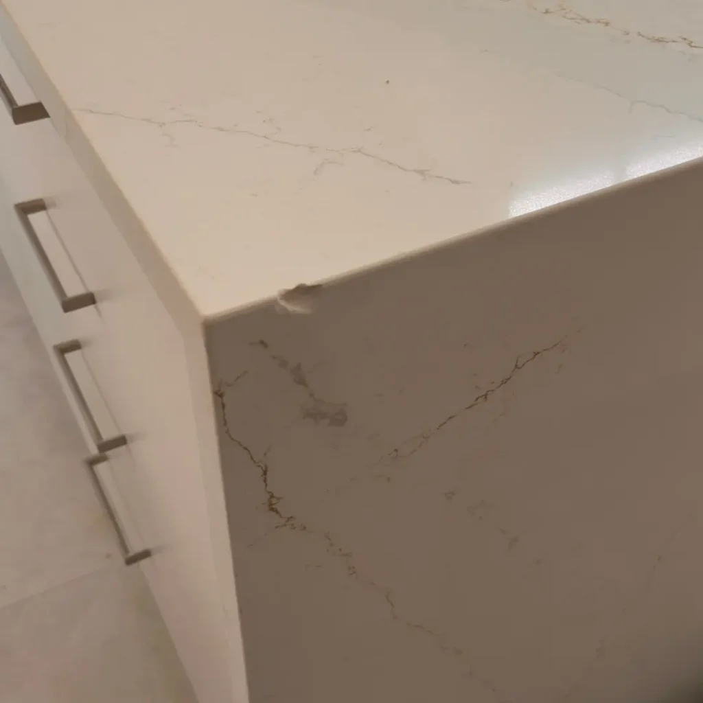 Chipped stone corner repaired — before